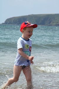 Cute boy running on beach