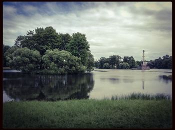 Scenic view of lake against cloudy sky