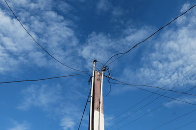 Low angle view of telephone pole against sky