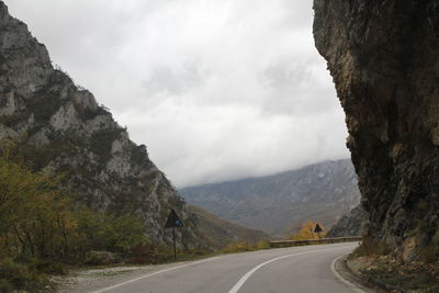 Road amidst mountains against sky