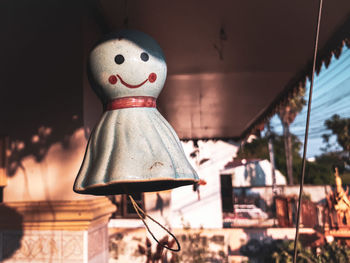 Close-up of ghost toy hanging outside house