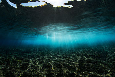Underwater shot of coral reef with sun rays
