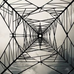 Low angle view of electricity pylon against sky
