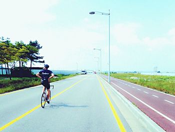 Woman cycling on road