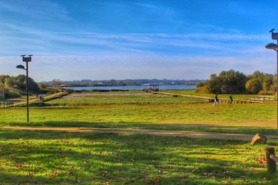 View of grassy field against sky