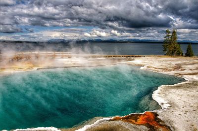 Scenic view of waterfall against sky