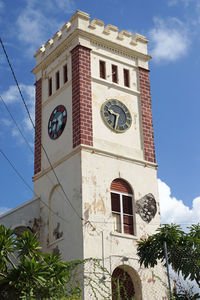 Low angle view of clock tower against sky