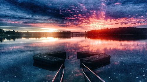 Scenic view of lake against sky at sunset