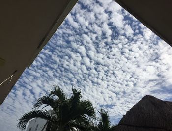 Low angle view of building against cloudy sky