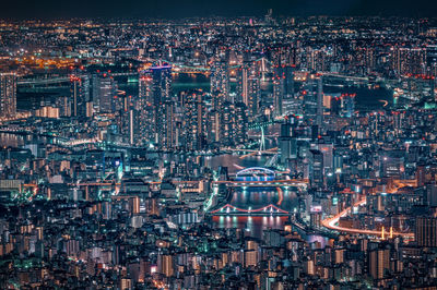 High angle view of city lit up at night