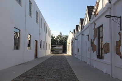 Empty alley amidst buildings in city