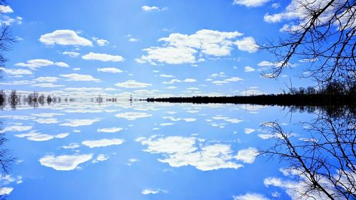 Snow covered landscape against blue sky