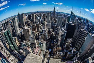 Aerial view of modern buildings in city against sky