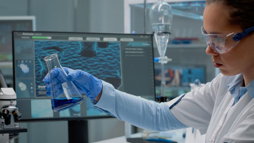 Doctor examining chemical in laboratory