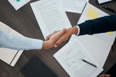 Cropped image of business colleagues shaking hands at office