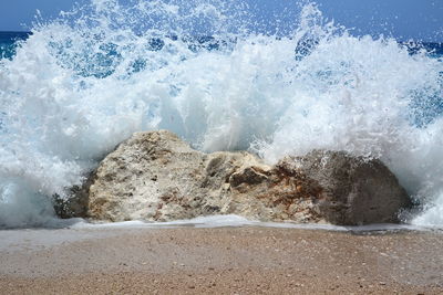 Waves splashing on rocks at beach