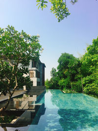 Buildings by swimming pool against sky