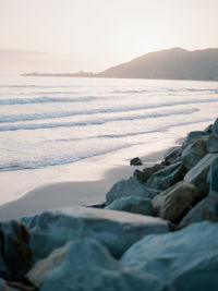 Scenic view of beach against sky during sunset