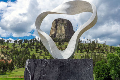 Sculpture on rock against sky