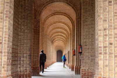Rear view of people walking in building
