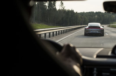 Cars on road seen through car windshield