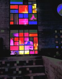 Multi colored glass window of illuminated building