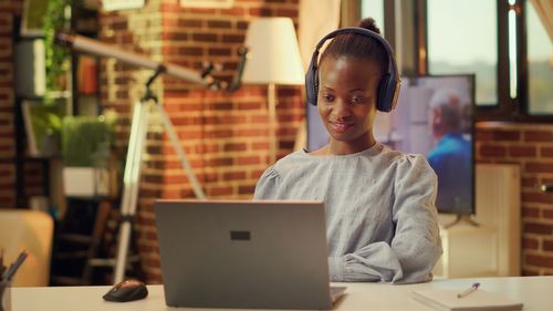 Young woman using laptop at cafe