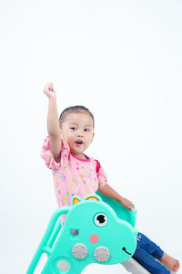 Portrait of cute baby boy with toy against white background