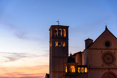 Basilica of san francisco in assisi against sky during sunset