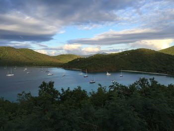 Scenic view of lake by trees against sky