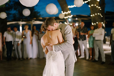 Rear view of couple standing against blurred background