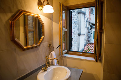 Small bathroom with mirror and sink and window