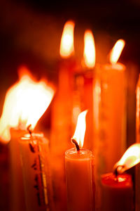 Close-up of lit candles in temple