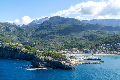 Scenic view of sea and mountains against sky