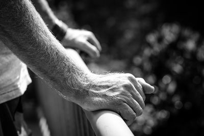 Close-up of man hand holding railing