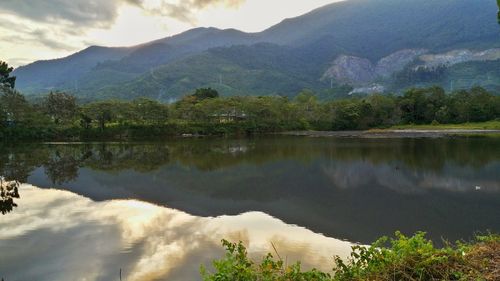 Scenic view of lake and mountains against sky