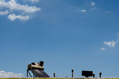 Low angle view of birds flying against blue sky