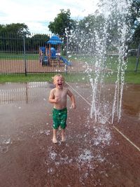 Very happy little boy playing at a splash pad