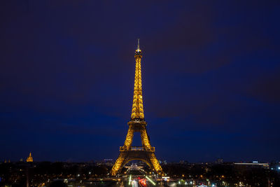 Illuminated buildings in city against sky