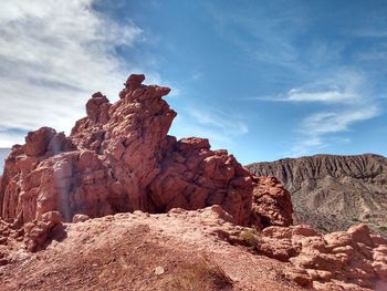 Rock formations on landscape against sky