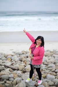 Full length portrait of woman standing on beach