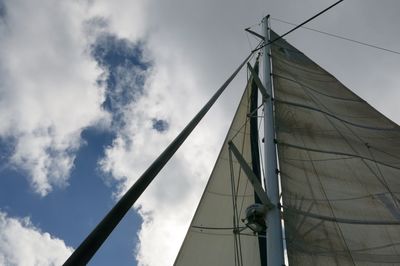 Low angle view of sailboat on sea against sky