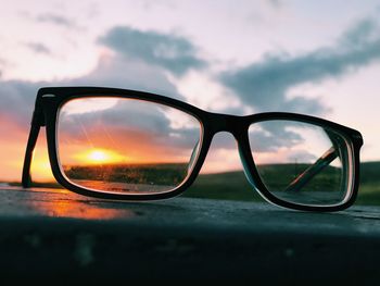 Close-up of sunglasses against sky