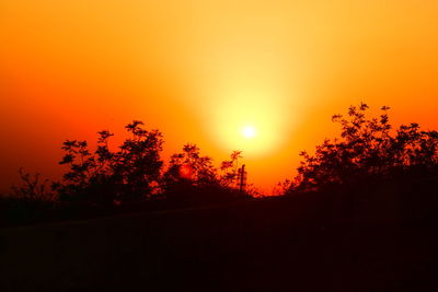 Silhouette trees against sky during sunset