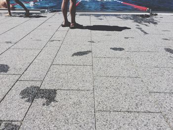 Low section of man on floor at pool