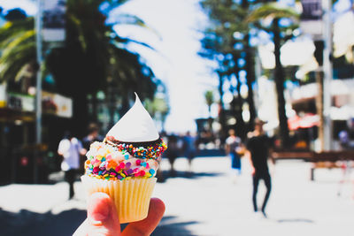 Close-up of hand holding cupcake