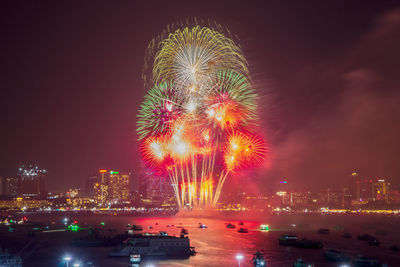 Fantastic and colorful fireworks display over the night sky of the city during a festival