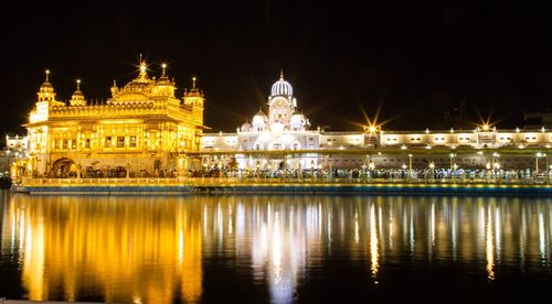 Reflection of illuminated building in water at night