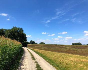 Empty road along countryside landscape