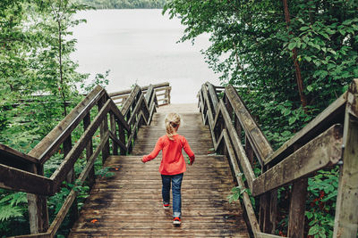 Full length of boy walking on footbridge